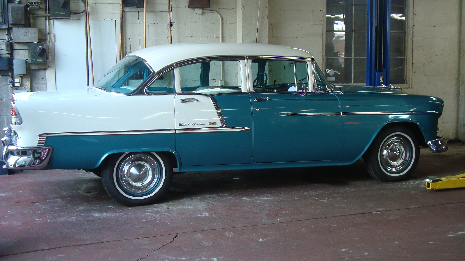 Turquoise and white 1955 Chevrolet Bel Air in a service bay at Ladner Motors auto repair shop in Delta BC