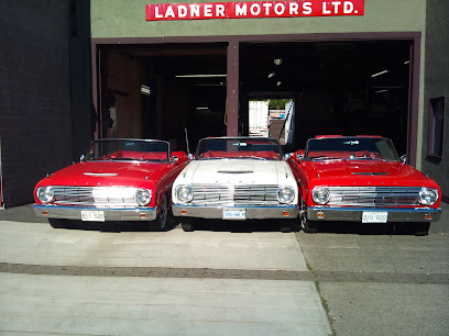 Three classic convertibles parked outside the Ladner Motors Ltd. service bays on Delta Street in Ladner, Delta BC